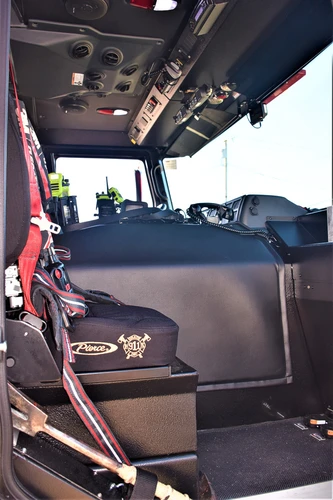 Cab interior side view showing seat row, center console, and interior trim