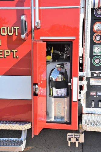 Open side panel showing a compact pump control section and intake fittings