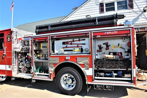 Driver-side profile with compartments open showing full equipment layout