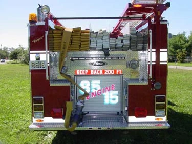 Rear view showing hose stacks in hosebed and rear warning lights