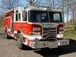 Pumper front-left exterior view showing enclosed cab and side compartments