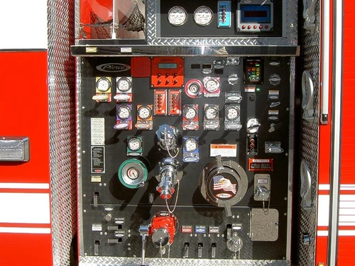 Pump panel close-up showing gauges, valves, and intake controls