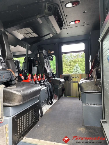 Cab interior side view showing rear seating and equipment cabinet area