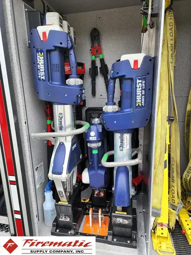Open narrow compartment showing mounted long tools and straps