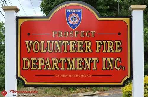 Roadside sign close-up showing volunteer fire department lettering