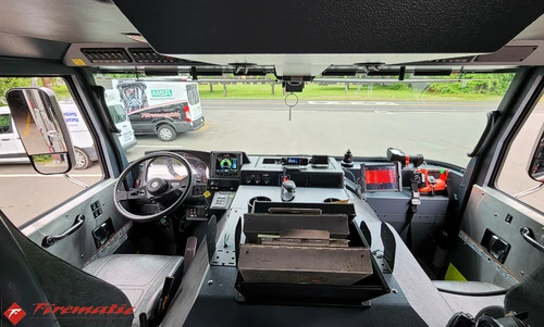Cab interior wide view showing dashboard, center console, and windshield
