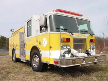 Pumper front-left view with grille, front wheel, and side body compartments