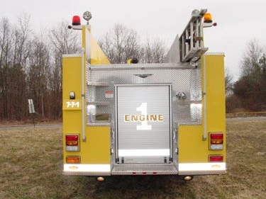Rear view showing roll-up rear door, upper ladders, and rear warning lights