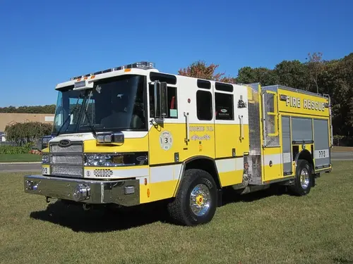 Heavy rescue truck front-left exterior view showing enclosed cab and long body