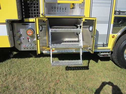 Open side compartment showing fold-down step tray and interior storage bay