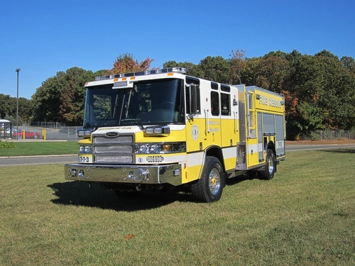 Front-left exterior view showing cab, grille, and side profile