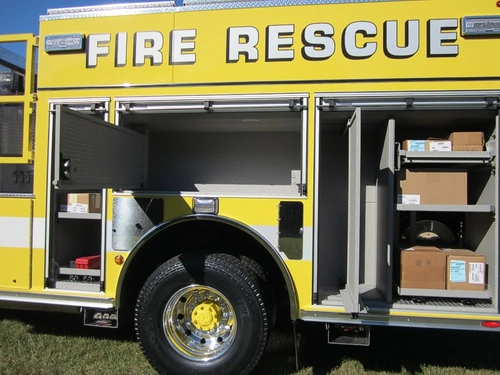Side compartment close-up showing empty shelf space and rear wheel area
