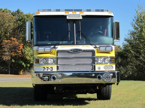 Head-on front view showing grille, bumper, and warning lights