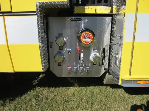 Pump-side control panel close-up showing gauges, valves, and intake ports