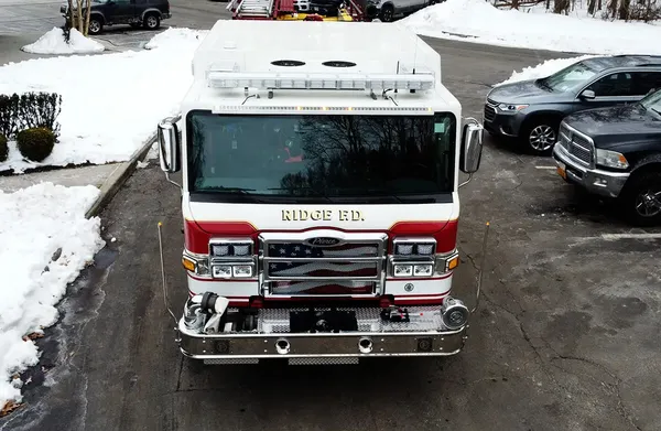 Pumper front view showing grille, bumper intake, and warning lights