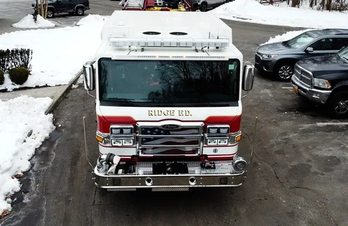 Pumper front view showing grille, bumper intake, and warning lights