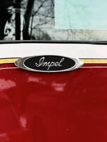 Cab door crest close-up showing Maltese-cross style emblem