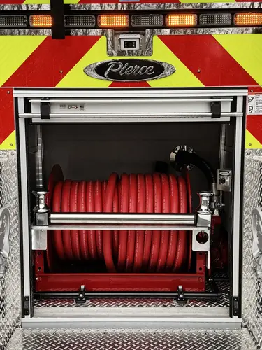 Front bumper corner close-up showing mounted bracket and reflective striping