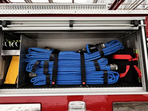Open side compartment showing vertical storage channels and tool mounts