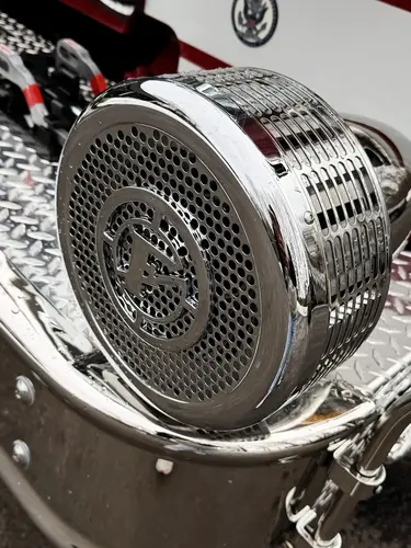 Round side marker light close-up on silver body panel
