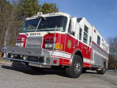 Heavy rescue truck front-left exterior view showing enclosed cab and long body