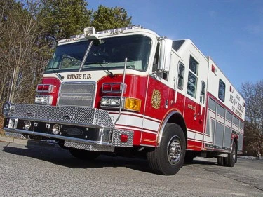 Heavy rescue truck front-left exterior view showing enclosed cab and long body