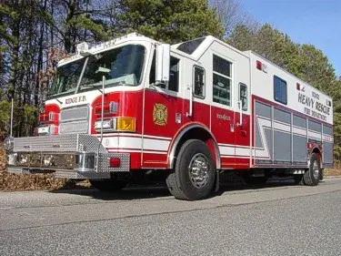 Heavy rescue truck front-left profile showing crew cab and long body