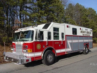 Heavy rescue truck side profile view showing cab and rear body compartments