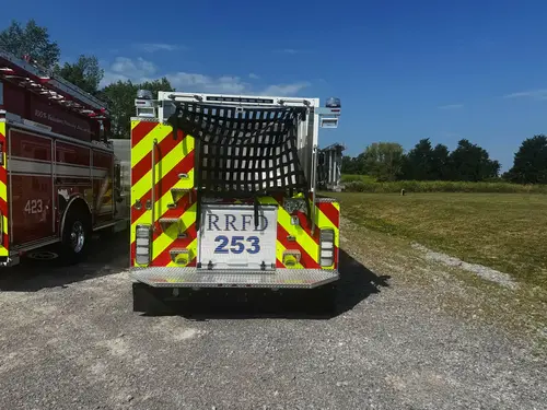 Rear exterior view showing chevron striping, hosebed netting, and rear lights