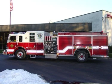 Driver-side profile view showing pump panel and wheel area