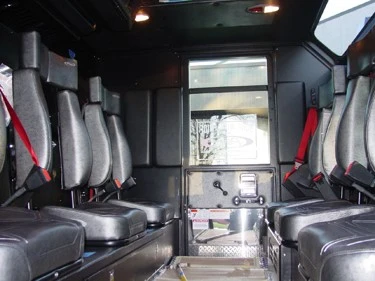 Rear crew cab interior view showing bench seats, aisle, and seatbelts