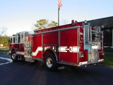 Rear-right exterior view showing side body compartments and rear wheel