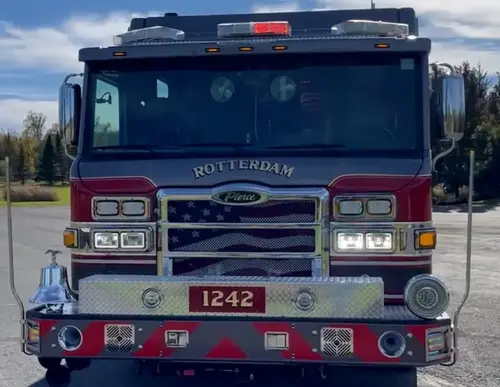 Head-on front view showing grille, bumper, and warning lights