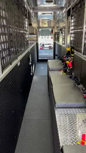 Interior walk-through view showing long aisle and side equipment racks