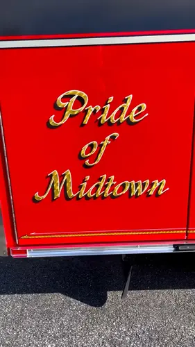 Body panel close-up showing decorative lettering on red paint