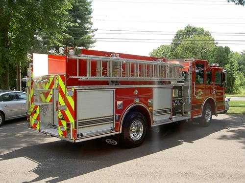 Rear-left exterior view showing side hosebed rails and rear body