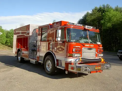 Rescue pumper front-left exterior view showing enclosed cab and side body compartments