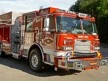 Front-left exterior view showing grille, cab, and side compartments