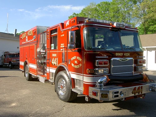 Front-left exterior view showing bumper, cab, and side body panels