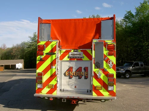 Rear view showing chevron striping, rear door, and covered hosebed area