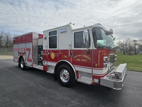 Pumper front-right exterior view showing enclosed cab, side compartments, and front bumper intake