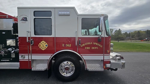 Cab side close-up showing crew-cab doors, front wheel, and bumper intake