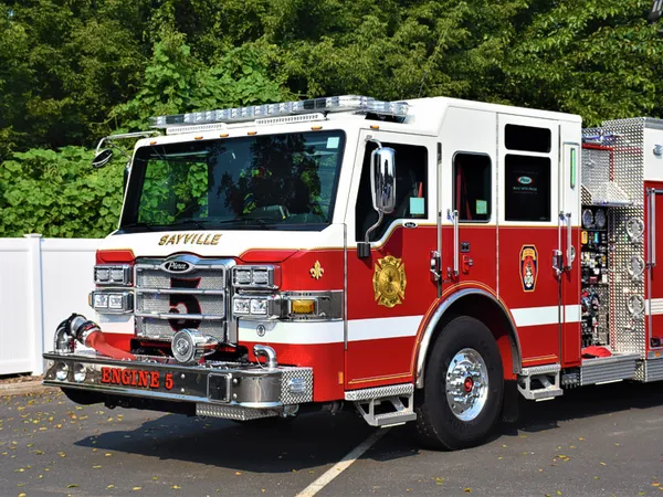 Pumper front-left exterior view showing grille, bumper, and enclosed cab