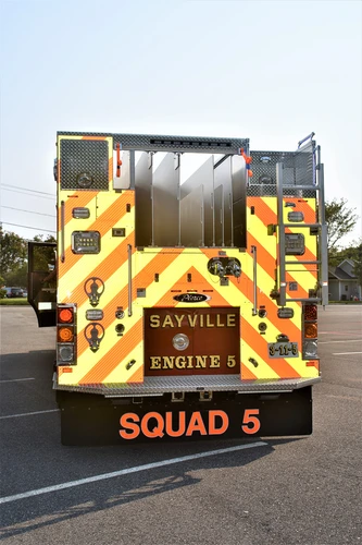 Rear view showing red-and-yellow chevrons, rear lights, and rear body panel