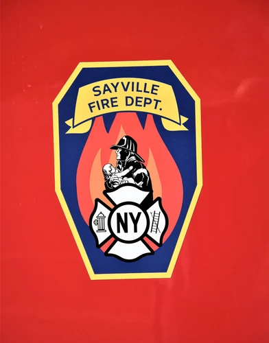Body emblem close-up showing a shield-style department logo on red paint