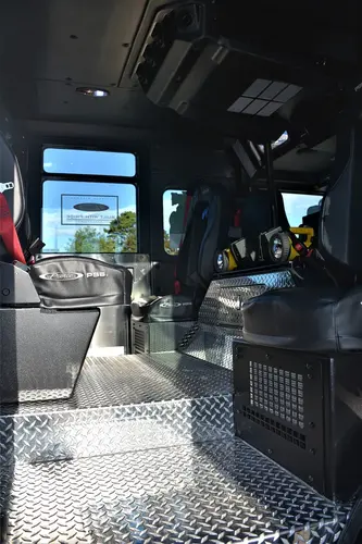 Crew cab interior view showing aisle, seating, and rear compartment area