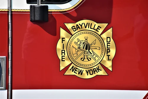 Cab door close-up showing a Maltese-cross style department crest