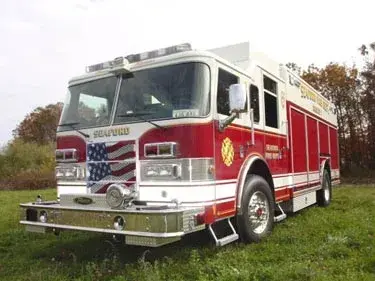Rescue pumper front-left exterior view with enclosed cab and side compartments