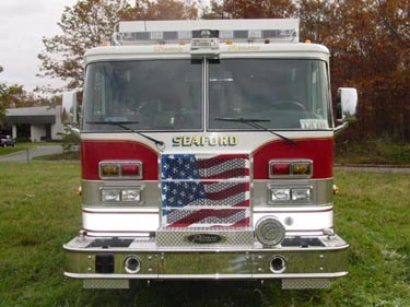 Front exterior view showing bumper, grille, and warning light bar