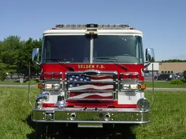 Head-on front view showing grille, windshield, warning lights, and bumper intake ports.